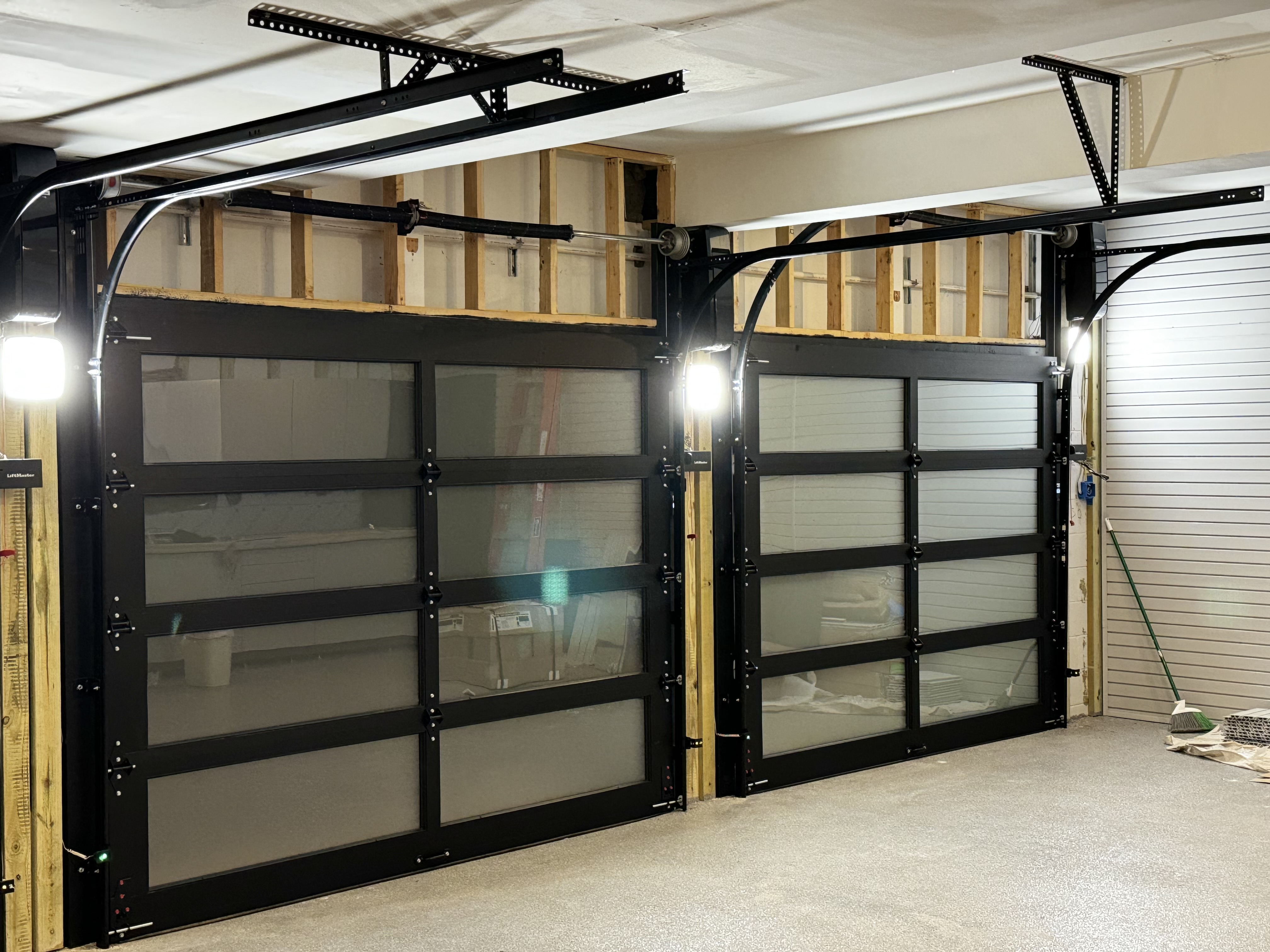 Black aluminum glass garage doors installed by My Main Door