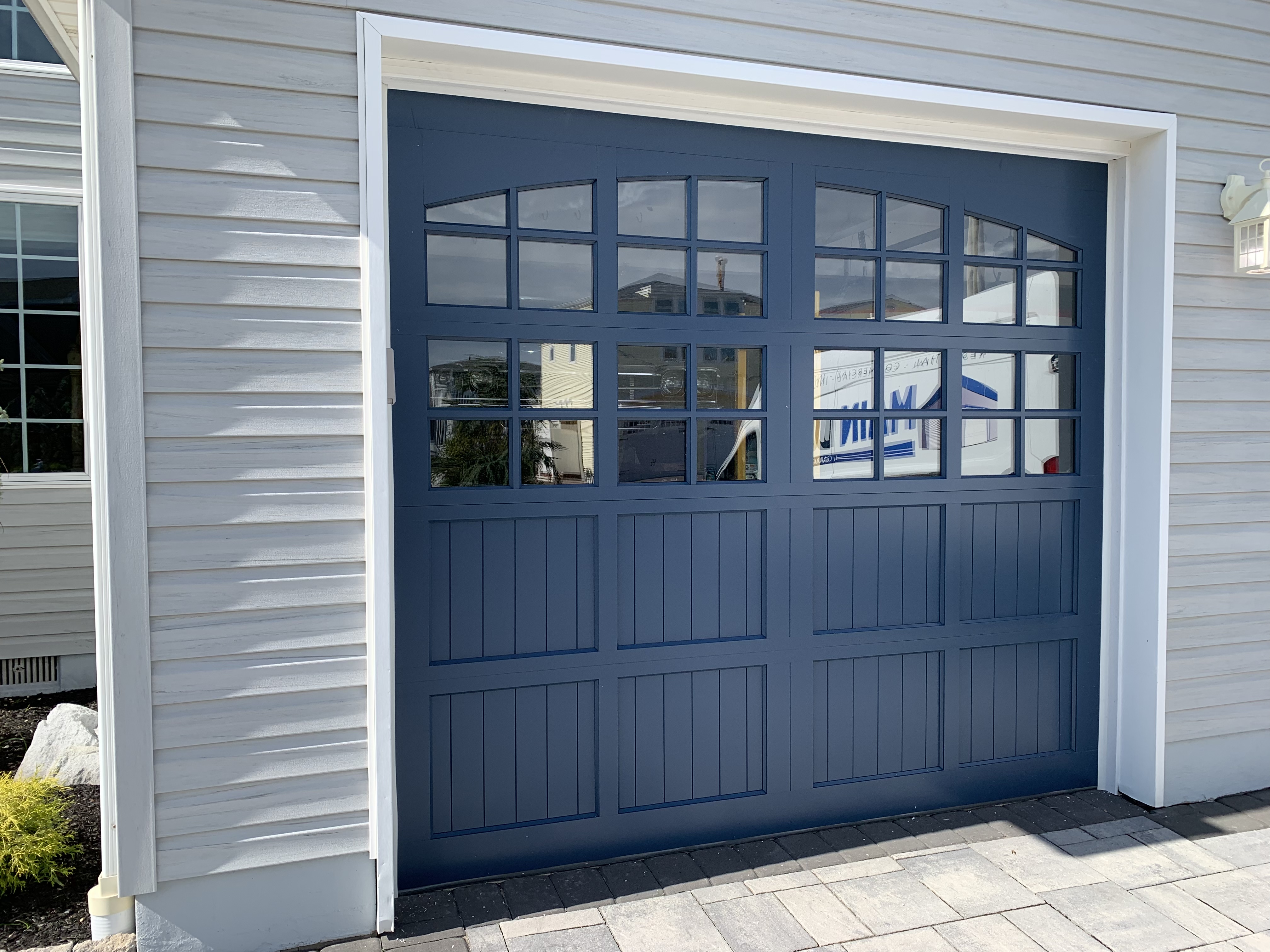 Navy blue carriage-style garage door installation
