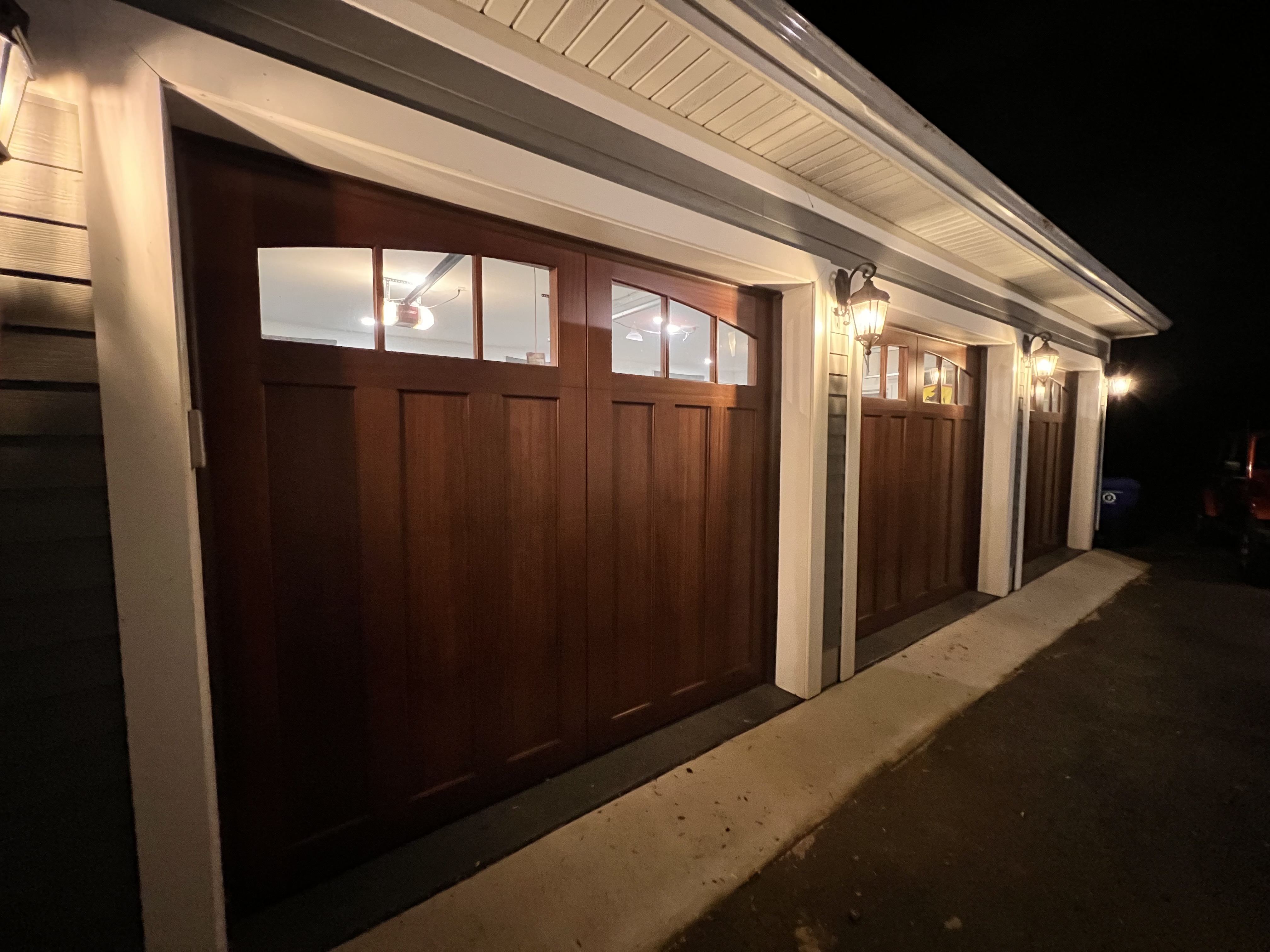Wood-finish carriage doors lit up at night
